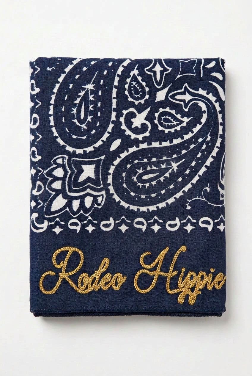 Trestles Clothing Company navy blue stonewashed bandana with white paisley print and gold Rodeo Hippie embroidery